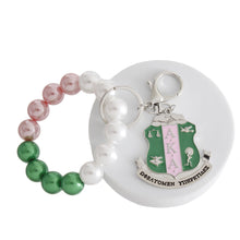 Load image into Gallery viewer, AKA Pink Green Pearl Shield Keychain
