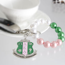 Load image into Gallery viewer, AKA Pink Green Pearl Shield Keychain
